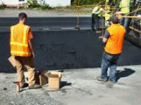 Checking asphalt application.